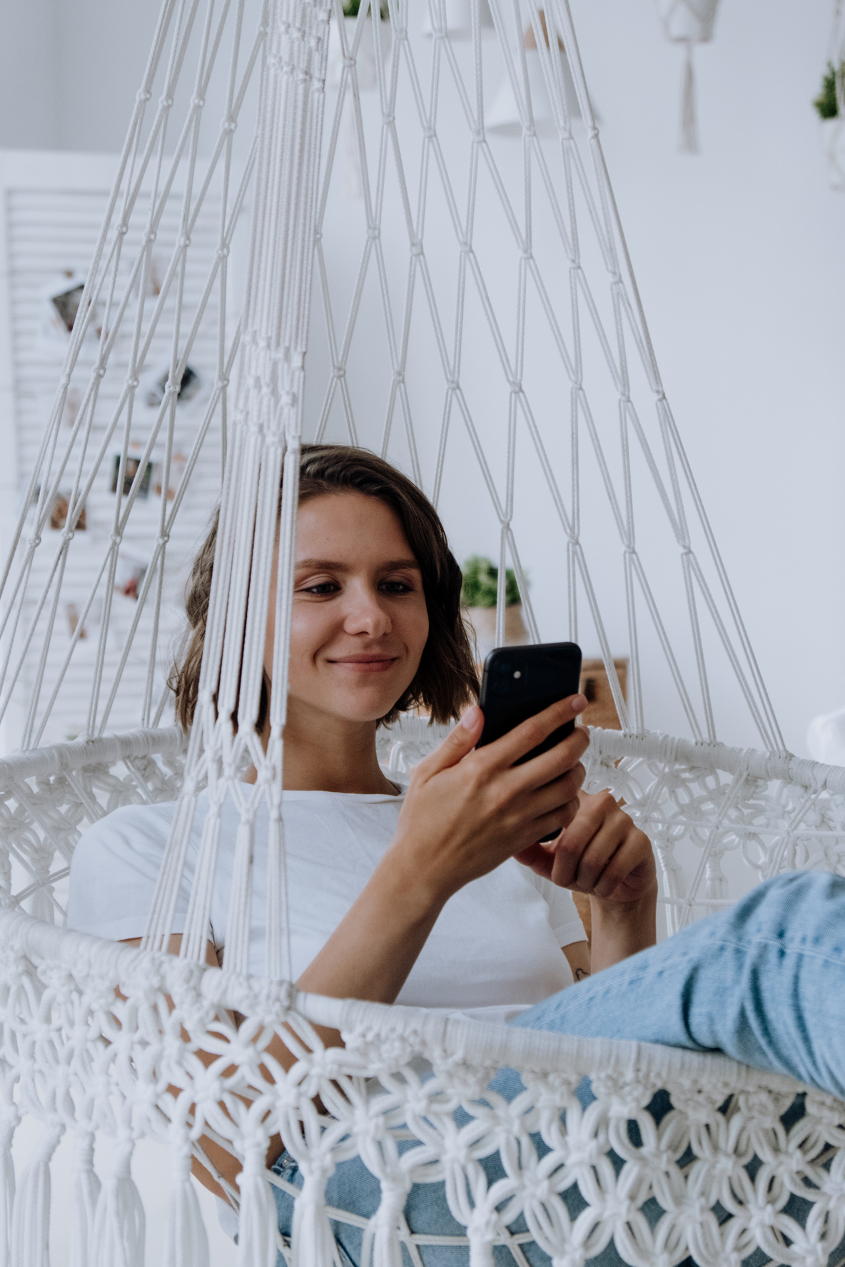 Woman in White Dress Holding Black Smartphone